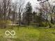Secluded log home nestled amongst mature trees and lush greenery offers a private retreat at 7971 Conarroe Rd, Indianapolis, IN 46278