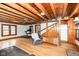 The living room has an exposed beam ceiling, hardwood floors, and a staircase leading to the upper level at 7971 Conarroe Rd, Indianapolis, IN 46278