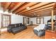 A cozy living room featuring wood-beamed ceilings and rustic charm with comfortable furniture at 7971 Conarroe Rd, Indianapolis, IN 46278