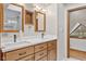 Bright bathroom featuring double sinks with wood cabinets, as well as a framed mirror at 800 N 400 W, Bargersville, IN 46106