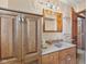 Traditional bathroom features wood cabinets, granite counters, and a framed mirror at 800 N 400 W, Bargersville, IN 46106