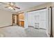 Carpeted bedroom with a ceiling fan, closet, and built in shelving unit at 800 N 400 W, Bargersville, IN 46106