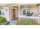 Inviting covered front porch featuring a wooden swing, ceiling fan, and stylish front door at 800 N 400 W, Bargersville, IN 46106