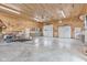 Large garage featuring multiple garage doors, concrete floors, and wood paneled walls at 800 N 400 W, Bargersville, IN 46106