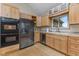 Bright kitchen features stainless steel appliances, lots of custom wood cabinetry, and hardwood floors at 800 N 400 W, Bargersville, IN 46106