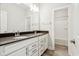 Bathroom with a double sink vanity, dark countertop, and a shower/tub with white tile at 848 Kinzer Ave, Carmel, IN 46032