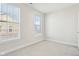 An empty bedroom features neutral carpet and white walls with windows allowing for natural light at 848 Kinzer Ave, Carmel, IN 46032