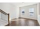 Spacious bonus room featuring hardwood floors, two windows with blinds, and staircase with dark metal banisters at 848 Kinzer Ave, Carmel, IN 46032