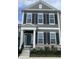 Charming two-story townhome featuring a dark-blue front door, large windows, black shutters, and a well-maintained lawn at 848 Kinzer Ave, Carmel, IN 46032