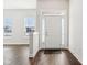 Bright foyer boasts hardwood floors, a white front door with sidelights and transom window, and neutral wall color at 848 Kinzer Ave, Carmel, IN 46032