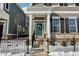 Inviting front entrance of the home features white pillars, a teal door with a wreath, and steps leading to the entrance at 848 Kinzer Ave, Carmel, IN 46032