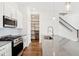 Bright kitchen area featuring stainless steel appliances, kitchen island, and a staircase nearby at 848 Kinzer Ave, Carmel, IN 46032