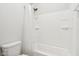 Bathroom shower/tub with a white shower curtain and white tile walls at 848 Kinzer Ave, Carmel, IN 46032