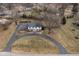 Traditional two-story home with a circular driveway and well-maintained lawn at 8825 Dunsmuir Dr, Indianapolis, IN 46260