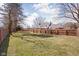Large backyard with wooden fence and mature trees at 8825 Dunsmuir Dr, Indianapolis, IN 46260