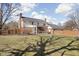 Wide backyard showing expansive lawn, wood fence, and patio at 8825 Dunsmuir Dr, Indianapolis, IN 46260