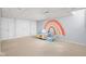 A finished basement with a small play area and rainbow wall art at 8825 Dunsmuir Dr, Indianapolis, IN 46260