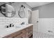 Updated bathroom featuring dual vanity with marble countertop and modern fixtures at 8825 Dunsmuir Dr, Indianapolis, IN 46260