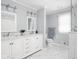 Bright bathroom with double vanity, marble countertop, and modern fixtures at 8825 Dunsmuir Dr, Indianapolis, IN 46260