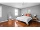 Sunlit bedroom with hardwood floors, and plush bedding at 8825 Dunsmuir Dr, Indianapolis, IN 46260