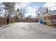 Long driveway leading to attached garage, with basketball hoop and trash receptacles visible at 8825 Dunsmuir Dr, Indianapolis, IN 46260