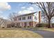 Charming two-story home with a brick and white facade and a well-manicured lawn at 8825 Dunsmuir Dr, Indianapolis, IN 46260