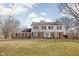Charming two-story home with a brick and white facade and a well-manicured lawn at 8825 Dunsmuir Dr, Indianapolis, IN 46260