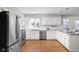 Bright kitchen with granite countertops, white cabinets, and stainless steel appliances at 8825 Dunsmuir Dr, Indianapolis, IN 46260