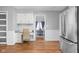 Eat-in kitchen offers stainless steel appliances, desk, and a view into the dining room at 8825 Dunsmuir Dr, Indianapolis, IN 46260