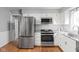 Stainless steel appliances and white cabinets in this bright and spacious kitchen at 8825 Dunsmuir Dr, Indianapolis, IN 46260
