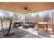 Screened-in patio featuring wood ceiling, ceiling fan, and cozy seating with outdoor dining set and fenced-in yard at 8825 Dunsmuir Dr, Indianapolis, IN 46260