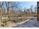 Wooden back deck with a view of the spacious backyard and the surrounding trees at 901 Detroit St, Beech Grove, IN 46107
