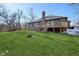 Expansive backyard with a deck, grass, and wooded areas at 901 Detroit St, Beech Grove, IN 46107