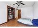 Simple bedroom featuring hardwood floors, closet, and view of the window at 901 Detroit St, Beech Grove, IN 46107