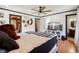 Bedroom featuring a large bed, a TV, and a view into the bathroom and walk-in closet at 901 Detroit St, Beech Grove, IN 46107