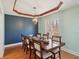 Formal dining room featuring decorative ceiling trim and a stylish chandelier at 901 Detroit St, Beech Grove, IN 46107
