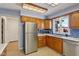 Bright kitchen featuring stainless steel appliances and blue tiled backsplash at 901 Detroit St, Beech Grove, IN 46107