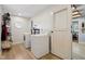 Bright laundry room featuring modern washer and dryer units, and white paneled door at 901 Detroit St, Beech Grove, IN 46107