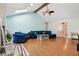 Open-concept living room with vaulted ceiling, brick fireplace, hardwood floors, and a large comfortable sofa at 901 Detroit St, Beech Grove, IN 46107