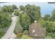 Aerial view of the wooded property featuring a lake view, mature trees, and neighborhood street at 9658 Farragut, Indianapolis, IN 46256