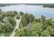 Aerial view of wooded property with lake in the background and lush trees at 9658 Farragut, Indianapolis, IN 46256