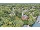 Stunning aerial view of an estate home nestled on a lake with mature trees and a private boat dock at 9658 Farragut, Indianapolis, IN 46256