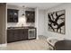 Finished basement bar with dark cabinetry and stainless steel beverage cooler at 9658 Farragut, Indianapolis, IN 46256