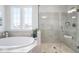 Bright bathroom with a large soaking tub, and glass-enclosed shower for a relaxing experience at 9658 Farragut, Indianapolis, IN 46256