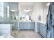 Bathroom featuring a glass shower, double vanity, and blue accents for a spa-like feel at 9658 Farragut, Indianapolis, IN 46256