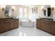 Elegant bathroom with a soaking tub, double vanity, and modern fixtures at 9658 Farragut, Indianapolis, IN 46256