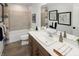 Bathroom vanity with a large mirror and neutral-toned shower/tub combination at 9658 Farragut, Indianapolis, IN 46256
