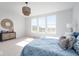 Bright bedroom with three large windows, woven light fixture, and decorative furnishings at 9658 Farragut, Indianapolis, IN 46256