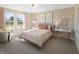 Bright bedroom with large windows, floral wallpaper, desk and chair at 9658 Farragut, Indianapolis, IN 46256