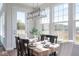 Dining room featuring a modern light fixture, large windows with scenic views, and a stylish dining table at 9658 Farragut, Indianapolis, IN 46256